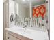 Stylish bathroom with a white sink vanity, decorative backsplash, and modern fixtures and mirror at 8397 Chase Dr, Arvada, CO 80003