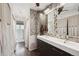 Modern bathroom with double sink vanity, stylish mirrors and tile accents at 8397 Chase Dr, Arvada, CO 80003