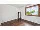 Clean bedroom with hardwood floors, a window and a standing mirror at 8397 Chase Dr, Arvada, CO 80003