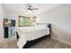 Bright bedroom with wood-trimmed windows, ceiling fan and dark furniture at 8397 Chase Dr, Arvada, CO 80003