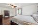 Bedroom with hardwood floors, large window and ceiling fan for comfortable living at 8397 Chase Dr, Arvada, CO 80003