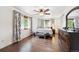 Comfortable bedroom with ceiling fan, hardwood floors, and two windows for natural light at 8397 Chase Dr, Arvada, CO 80003