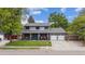 Charming two-story home with a well-maintained front yard and a welcoming covered porch at 8397 Chase Dr, Arvada, CO 80003