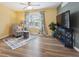 Cozy living area with plush seating, stylish curtains, and a modern TV setup at 8397 Chase Dr, Arvada, CO 80003