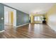Open-concept living room with hardwood floors, bright walls, and natural light at 8397 Chase Dr, Arvada, CO 80003