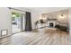 Spacious living room with brick fireplace, hardwood floors, and sliding glass doors at 8397 Chase Dr, Arvada, CO 80003