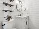 Modern powder room featuring shiplap walls, sleek fixtures, and stylish decor at 8397 Chase Dr, Arvada, CO 80003