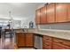 Kitchen features granite countertops, wood cabinets, stainless steel appliances, and a breakfast bar at 9019 E Panorama Cir # D416, Englewood, CO 80112