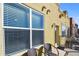 The patio has a bright stucco wall, two patio chairs, and large window at 9019 E Panorama Cir # D416, Englewood, CO 80112