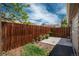 Small backyard area featuring a wood fence, concrete patio, and minimal landscaping at 3629 W Custer Pl, Denver, CO 80219
