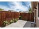 Small backyard area featuring a wood fence, concrete patio, and minimal landscaping at 3629 W Custer Pl, Denver, CO 80219