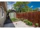 Backyard with shed, concrete patio, and wood fence at 3629 W Custer Pl, Denver, CO 80219