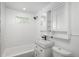 A modern bathroom with subway tile walls, vanity, and a shower head above the bathtub at 3629 W Custer Pl, Denver, CO 80219