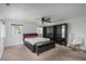 Cozy bedroom featuring carpet flooring, a ceiling fan, and large window at 3629 W Custer Pl, Denver, CO 80219