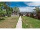 Charming single-story home with a long walkway, and a fenced yard under a partly cloudy sky at 3629 W Custer Pl, Denver, CO 80219