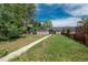 A charming single-story home with a long walkway, and fenced yard under a partly cloudy sky at 3629 W Custer Pl, Denver, CO 80219