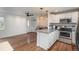 Modern kitchen and dining area featuring stainless steel appliances, and granite countertops at 3629 W Custer Pl, Denver, CO 80219