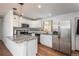 Modern kitchen featuring granite countertops, stainless steel appliances, and white cabinets at 3629 W Custer Pl, Denver, CO 80219