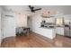 Bright open-concept kitchen and dining area with hardwood floors and granite countertops at 3629 W Custer Pl, Denver, CO 80219