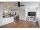 Bright open-concept living space with hardwood floors and a modern ceiling fan at 3629 W Custer Pl, Denver, CO 80219