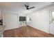 Bright open-concept living space with hardwood floors, modern ceiling fan, and a closet at 3629 W Custer Pl, Denver, CO 80219