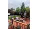 Inviting backyard patio with outdoor seating, lush landscaping, and a decorative clock at 1676 S Fairplay St, Aurora, CO 80012