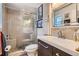Beautiful bathroom features a tiled shower with glass doors, a modern vanity, and stylish fixtures at 1676 S Fairplay St, Aurora, CO 80012