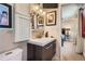 Modern bathroom with sleek vanity, tiled backsplash, and a view into the bedroom at 1676 S Fairplay St, Aurora, CO 80012