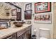 Charming bathroom featuring a vessel sink, stylish vanity, and unique decorative artwork at 1676 S Fairplay St, Aurora, CO 80012