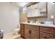 Bathroom features a double sink vanity with a large framed mirror at 1676 S Fairplay St, Aurora, CO 80012