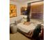 Cozy bedroom featuring neutral walls, a metal-framed bed, and lively jazz-themed artwork at 1676 S Fairplay St, Aurora, CO 80012