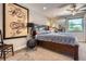 Bedroom featuring a large bed, stylish lighting, ceiling fan, and a modern dragon painting at 1676 S Fairplay St, Aurora, CO 80012