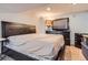 Bedroom features a bed with padded headboard, neutral walls, and dresser at 1676 S Fairplay St, Aurora, CO 80012
