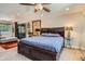 Bedroom with a ceiling fan, large bed with drawers, and a comfy sitting area at 1676 S Fairplay St, Aurora, CO 80012