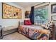 Cozy bedroom with colorful quilt, abstract art, and a comfortable bench by the window at 1676 S Fairplay St, Aurora, CO 80012