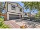 Charming two-story home showcasing a driveway and inviting front entrance with a well-manicured lawn at 1676 S Fairplay St, Aurora, CO 80012
