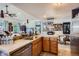 Bright and modern kitchen featuring tile countertops, modern appliances, and adjacent dining space at 1676 S Fairplay St, Aurora, CO 80012