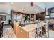 Spacious kitchen features large island with barstool seating and stainless steel refrigerator at 1676 S Fairplay St, Aurora, CO 80012