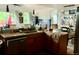 Functional kitchen with wood cabinetry and stainless steel dishwasher, offering a cozy dining area at 1676 S Fairplay St, Aurora, CO 80012