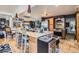 Open kitchen with a large island, stainless steel appliances, wine cooler, and unique decor at 1676 S Fairplay St, Aurora, CO 80012