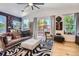 Bright living room with hardwood floors, stylish decor, and sliding glass doors to outdoor patio at 1676 S Fairplay St, Aurora, CO 80012