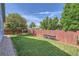 Well-maintained backyard featuring a lush lawn, wooden fence, and mature trees at 433 N 15Th Ave, Brighton, CO 80601