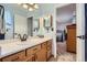 Well-lit bathroom boasting a wide vanity, mirrors, and access to a bedroom, providing convenience at 433 N 15Th Ave, Brighton, CO 80601