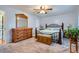 Charming bedroom with hardwood furnishings, a wrought iron bedframe, and soft, neutral decor for relaxation at 433 N 15Th Ave, Brighton, CO 80601
