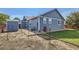 Exterior view of a blue home, showing the backyard and shed at 433 N 15Th Ave, Brighton, CO 80601