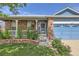 Inviting front entrance with brick accents and a blue garage door at 433 N 15Th Ave, Brighton, CO 80601