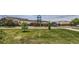 View of the front lawn and community buildings with mature trees and landscaping at 433 N 15Th Ave, Brighton, CO 80601