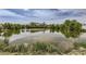Scenic view of the community pond reflecting the sky and surrounding greenery at 433 N 15Th Ave, Brighton, CO 80601