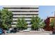 Multi-story building with balconies and trees in front of the building and Humboldt Place sign above the entrance at 1441 N Humboldt St # 302, Denver, CO 80218