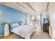 Bright bedroom with blue accent wall, neutral carpet and exposed concrete beams at 1441 N Humboldt St # 302, Denver, CO 80218